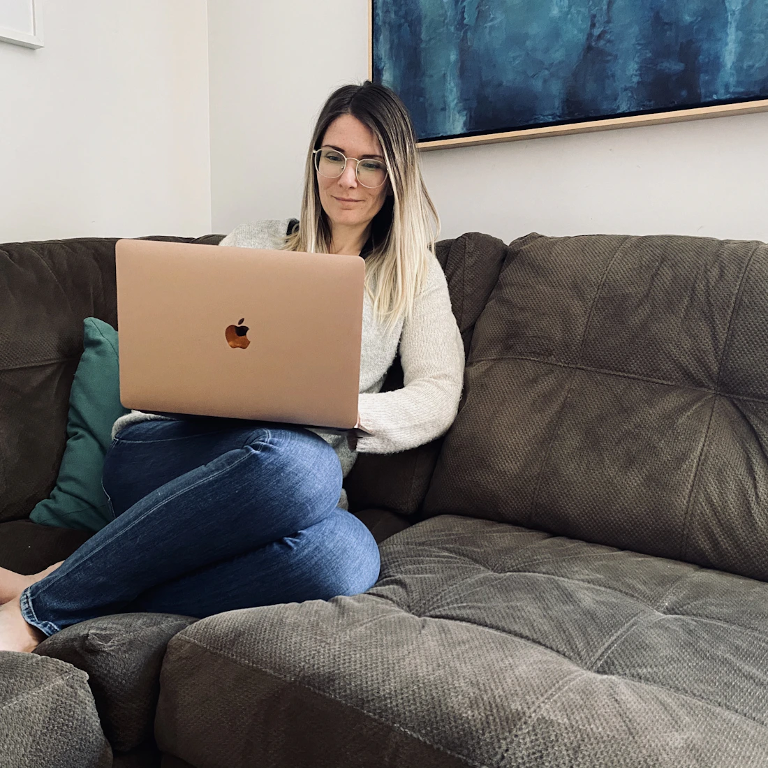 Remote professional working on a laptop from a sofa at home
